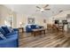 Open-concept living area with wood-style floors, comfortable seating, and an adjacent dining area at 3151 Britannia Blvd # C, Kissimmee, FL 34747