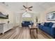 Inviting living room featuring wood floors, two sofas, and a large window for ample natural light at 3151 Britannia Blvd # C, Kissimmee, FL 34747