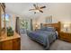 Spacious main bedroom with wood furnishings, ceiling fan, and balcony access at 3151 Britannia Blvd # C, Kissimmee, FL 34747