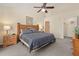 Large main bedroom with wood furniture, ceiling fan, and adjoining closet at 3151 Britannia Blvd # C, Kissimmee, FL 34747