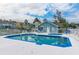 Community pool with blue trim, surrounded by lounge chairs and palm trees, near complex building at 3151 Britannia Blvd # C, Kissimmee, FL 34747