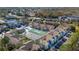 Wide aerial view of colorful community highlighting a pool, tennis courts, and lush surroundings at 8716 Rain Forest Pl # D, Kissimmee, FL 34747
