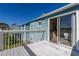 Balcony with white railing offering community views and providing access to a bright bedroom at 8716 Rain Forest Pl # D, Kissimmee, FL 34747
