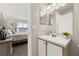 Well-lit bathroom with a vanity, mirror, and view into an adjacent bedroom with balcony access at 8716 Rain Forest Pl # D, Kissimmee, FL 34747