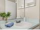 Well-lit bathroom features a vanity with sink, mirror, and neutral color scheme at 8716 Rain Forest Pl # D, Kissimmee, FL 34747