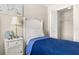 Bedroom featuring a twin bed with closet and side table with lamp at 8716 Rain Forest Pl # D, Kissimmee, FL 34747