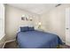 Comfortable bedroom with a cozy bed, side table, and neutral tones at 8716 Rain Forest Pl # D, Kissimmee, FL 34747