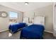 Cozy bedroom featuring twin beds and a view to the outside at 8716 Rain Forest Pl # D, Kissimmee, FL 34747