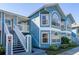 Charming two-story condo with blue siding, white trim, and well-maintained landscaping at 8716 Rain Forest Pl # D, Kissimmee, FL 34747