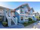 Charming two-story condo with blue siding, white trim, and well-maintained landscaping at 8716 Rain Forest Pl # D, Kissimmee, FL 34747