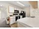 Functional kitchen layout with white cabinets and essential appliances at 8716 Rain Forest Pl # D, Kissimmee, FL 34747