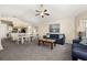 Inviting living room area features a sofa and ceiling fan and adjoins the dining and kitchen at 8716 Rain Forest Pl # D, Kissimmee, FL 34747