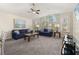 Inviting living room featuring large arched window, comfortable seating, and a ceiling fan at 8716 Rain Forest Pl # D, Kissimmee, FL 34747