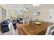 Open concept layout with a large arched window, comfortable seating, and a dining table at 8716 Rain Forest Pl # D, Kissimmee, FL 34747
