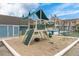 Community playground with a tire swing and slide, in a sand-filled play area at 8716 Rain Forest Pl # D, Kissimmee, FL 34747