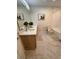 Elegant bathroom with double vanity, marble flooring, and a soaking tub at 2023 Claudia Ln, Kissimmee, FL 34741