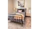 Well-appointed bedroom with a metal bed frame and neutral color palette at 2023 Claudia Ln, Kissimmee, FL 34741