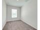 Simple bedroom with neutral wall and carpet, and a large window at 2023 Claudia Ln, Kissimmee, FL 34741