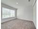 Bright bedroom with neutral wall and carpet, large window, and double door closet at 2023 Claudia Ln, Kissimmee, FL 34741