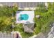 Aerial view of community pool with surrounding landscaping and parking at 2023 Claudia Ln, Kissimmee, FL 34741