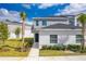 Two-story townhome with gray exterior, landscaping, and walkway at 2023 Claudia Ln, Kissimmee, FL 34741