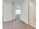 Bright hallway with carpet flooring and doors to bedrooms and bathroom at 2023 Claudia Ln, Kissimmee, FL 34741
