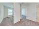 Bright hallway with carpet flooring and doors to bedrooms and bathroom at 2023 Claudia Ln, Kissimmee, FL 34741