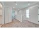 Spacious hallway with carpet flooring, linen closet, and doors to bedrooms at 2023 Claudia Ln, Kissimmee, FL 34741