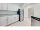 White kitchen cabinets, granite countertops, stainless steel appliances at 2023 Claudia Ln, Kissimmee, FL 34741