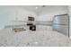 Modern kitchen with white cabinets, granite counters, stainless steel appliances at 2023 Claudia Ln, Kissimmee, FL 34741