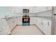 Modern kitchen with white cabinets, granite counters, and stainless steel appliances at 2023 Claudia Ln, Kissimmee, FL 34741