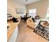 Open concept living and dining area with light flooring and large window at 2023 Claudia Ln, Kissimmee, FL 34741