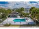 Community pool with a covered patio and surrounding fence at 2023 Claudia Ln, Kissimmee, FL 34741