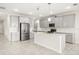 An open kitchen with an island, gray cabinets, stainless steel appliances, and tile flooring at 2949 Nottel Dr, St Cloud, FL 34772
