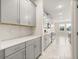 Modern kitchen with gray cabinets, stainless steel appliances, and tile flooring at 2949 Nottel Dr, St Cloud, FL 34772