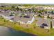 Aerial view of modern homes with solar panels on rooftops and serene waterfront views at 2949 Nottel Dr, St Cloud, FL 34772