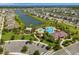 A beautiful aerial view of a community with a pool, playground, lake, and modern houses at 2949 Nottel Dr, St Cloud, FL 34772