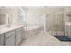 Luxurious bathroom featuring a soaking tub, glass-enclosed shower, and double vanity at 2949 Nottel Dr, St Cloud, FL 34772