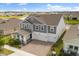 Stunning two-story home featuring a two-car garage, manicured landscaping, and a welcoming front porch at 2949 Nottel Dr, St Cloud, FL 34772