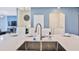 Modern kitchen island with double sink at 8932 Cabot Cliffs Dr, Davenport, FL 33896