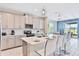 Modern kitchen with island and stainless steel appliances at 8932 Cabot Cliffs Dr, Davenport, FL 33896