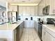Modern kitchen with island and stainless steel appliances at 8932 Cabot Cliffs Dr, Davenport, FL 33896