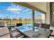 Covered patio with outdoor dining set and pool view at 8932 Cabot Cliffs Dr, Davenport, FL 33896