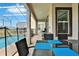 Covered patio includes an outdoor seating area, complemented by a grill and view of the pool at 8932 Cabot Cliffs Dr, Davenport, FL 33896