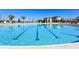Large community pool with swimming lanes, lounge chairs, and poolside amenities for relaxation and fitness at 8932 Cabot Cliffs Dr, Davenport, FL 33896