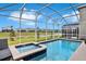 Relaxing screened pool and spa with lake view at 8932 Cabot Cliffs Dr, Davenport, FL 33896