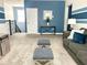 Recreation room with sofa and ottomans near staircase at 8932 Cabot Cliffs Dr, Davenport, FL 33896