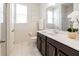 Single vanity bathroom with dark wood cabinets and shower at 9001 Sunshine Ridge Loop, Kissimmee, FL 34747