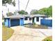 Cute bungalow with blue and white exterior, green door, and a detached garage at 905 W 11Th Ave, Mount Dora, FL 32757