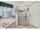 Bathroom with shower, tub, and a large vanity at 1287 Glendora Rd, Kissimmee, FL 34759